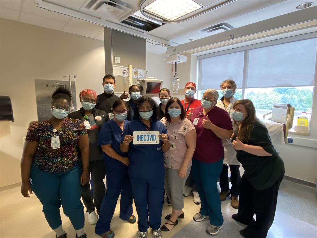 ICU staff gathered in a patient room